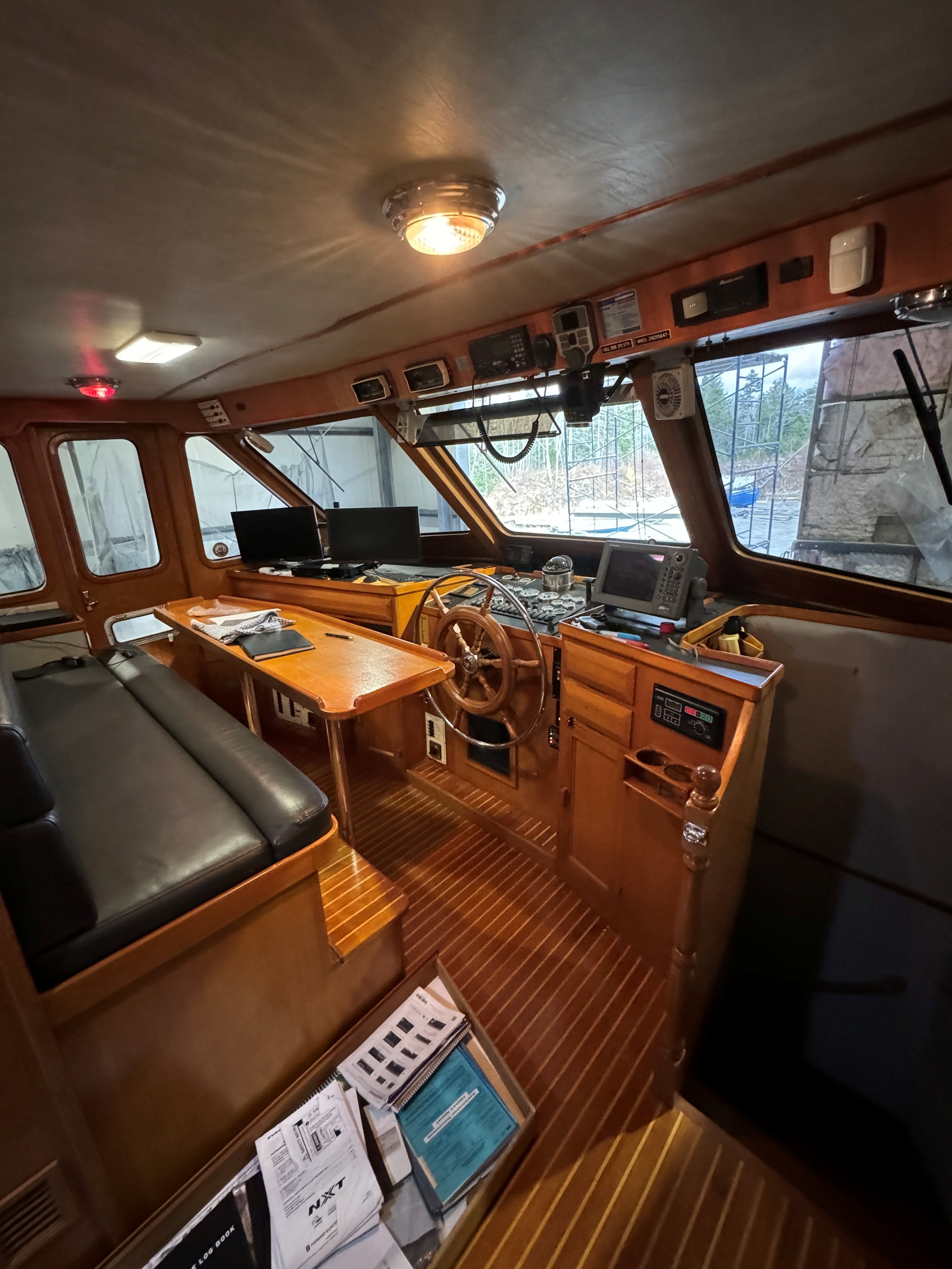 Classic wooden boat wheelhouse interior with navigation equipment